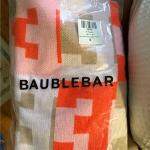BaubleBar Pink, Orange, and Tan Knit Throw with ‘E’ letter pattern